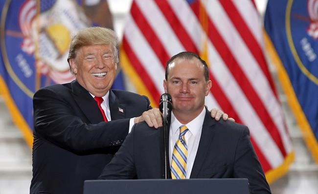 FILE - President Donald Trump stands with Sen. Mike Lee, R-Utah, on Dec. 4, 2017, at the Utah State Capitol. Two well-funded challengers will attempt to unseat second-term Lee in Utah's Republican primary in a race that will test whether loyalty to former President Donald Trump remains a litmus test for Republican voters. Lee will appear on the ballot alongside former state lawmaker Becky Edwards and political operative Ally Isom on Tuesday, June 28, 2022. (AP Photo/Rick Bowmer, File)