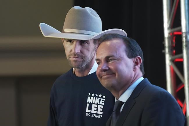 Utah Republican Party Chair Carson Jorgensen, left, and Utah U.S. Sen. Mike Lee listen to speakers during an Utah Republican election night party on June 28, 2022, in South Jordan, Utah. (AP Photo/George Frey)