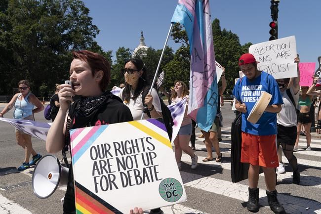 Abortion-rights protesters march on Capitol Hill, with the U.S. Capitol in the background, after protesting at the Supreme Court, Wednesday, June 29, 2022, in Washington. (AP Photo/Jacquelyn Martin)