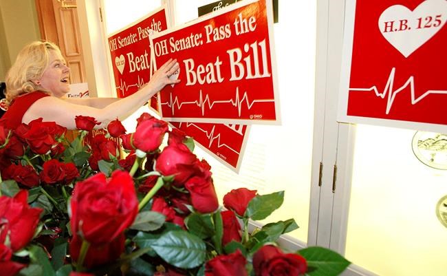 FILE - In this Feb. 14, 2012, file photo, Janet Folger Porter posts signs during a news conference at the Ohio Statehouse in Columbus, Ohio. An Ohio law banning most abortions once a