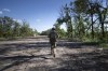 A Ukrainian serviceman changes his position at the frontline near Kharkiv, Ukraine, on Saturday, July 2, 2022. (AP Photo/Evgeniy Maloletka)