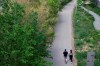 A couple holds hands as they walk along the West Toronto Railpath during Sunday, May 23, 2021. A new tranche of census data shows Canadians are increasingly likely to live in common-law partnerships rather than officially tying the knot. THE CANADIAN PRESS/Tijana Martin