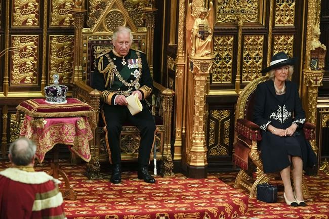 FILE - Prince Charles reads the Queen's speech as Camilla Duchess of Cornwall, listens, both seated next to the Queen's crown during the State Opening of Parliament, at the Palace of Westminster in London, May 10, 2022. Camilla, the Duchess of Cornwall, will celebrate her 75th birthday on Sunday, July 17, 2022 marking the occasion with a small family dinner at Prince Charles’ Highgrove estate in southwest England. (AP Photo/Alastair Grant, Pool, File)