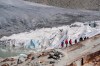 People visit the Rhone Glacier covered in blankets above Gletsch near the Furkapass in Switzerland, on Wedensday, 13 July 2022. The Alps oldest glacier is protected by special white blankets to prevent it from melting. (Urs Flueeler/Keystone via AP)
