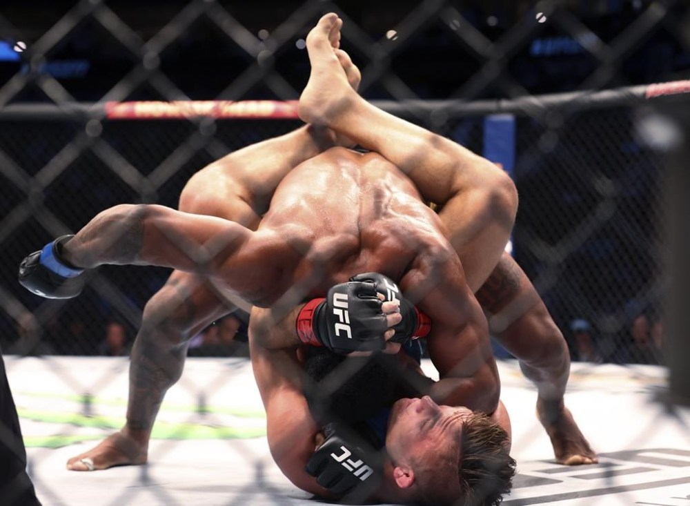 Rafael Alves battles Drew Dober on the mat in a lightweight mixed martial arts bout at UFC 277 on Saturday, July 30, 2022, in Dallas. (AP Photo/Richard W. Rodriguez)