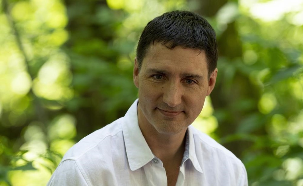 Canadian Prime Minister Justin Trudeau is seen as he speaks with children during an event, Friday, July 15, 2022 in Chelsea, Quebec. THE CANADIAN PRESS/Adrian Wyld