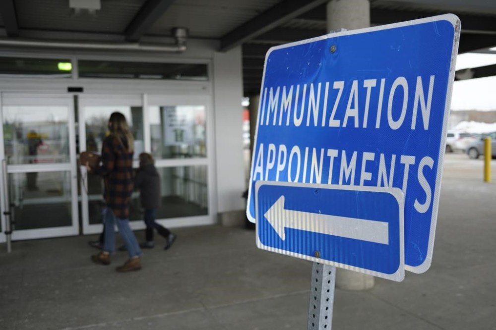 A family arrives for an appointment at a COVID-19 immunization clinic in Regina on Nov. 24, 2021. THE CANADIAN PRESS/Michael Bell