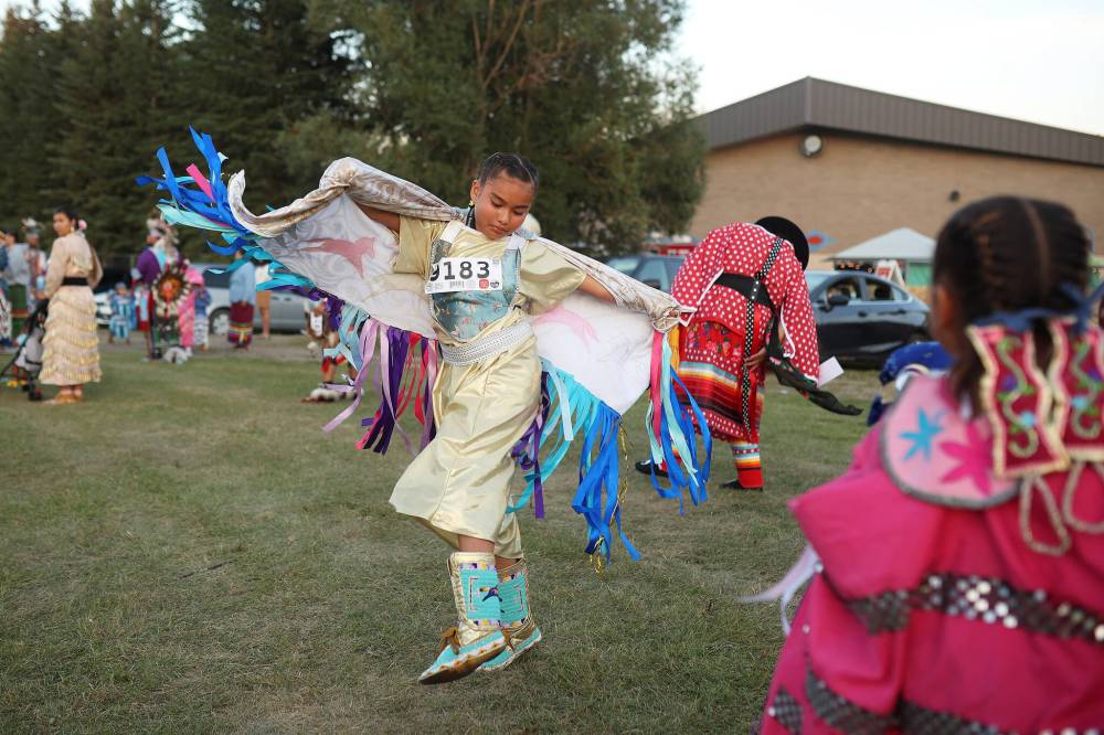 Paris Thompson, of Winnipeg, dances while waiting to take part in the Grand Entry at the Sioux Valley Dakota Nation Powwow Friday evening. (Tim Smith/The Brandon Sun)