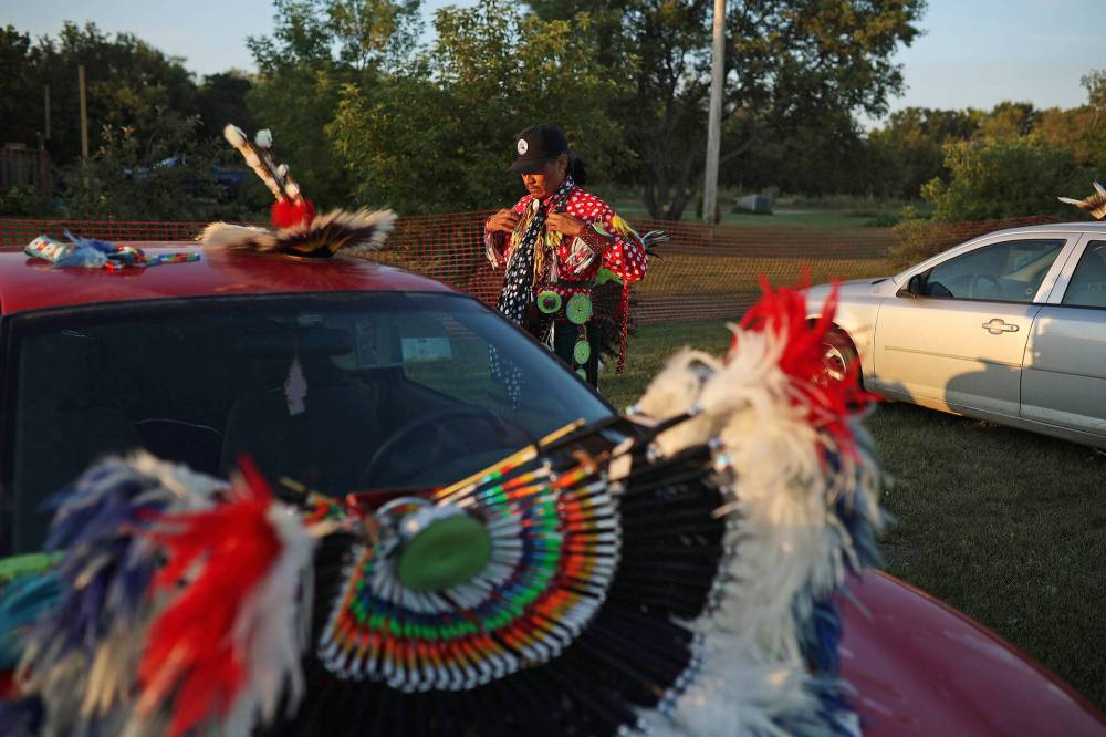 Quentin PJ Tootoosis, of Poundmaker First Nation, finishes putting on his regalia prior to the Sioux Valley Dakota Nation Powwow Friday evening. (Tim Smith/The Brandon Sun)