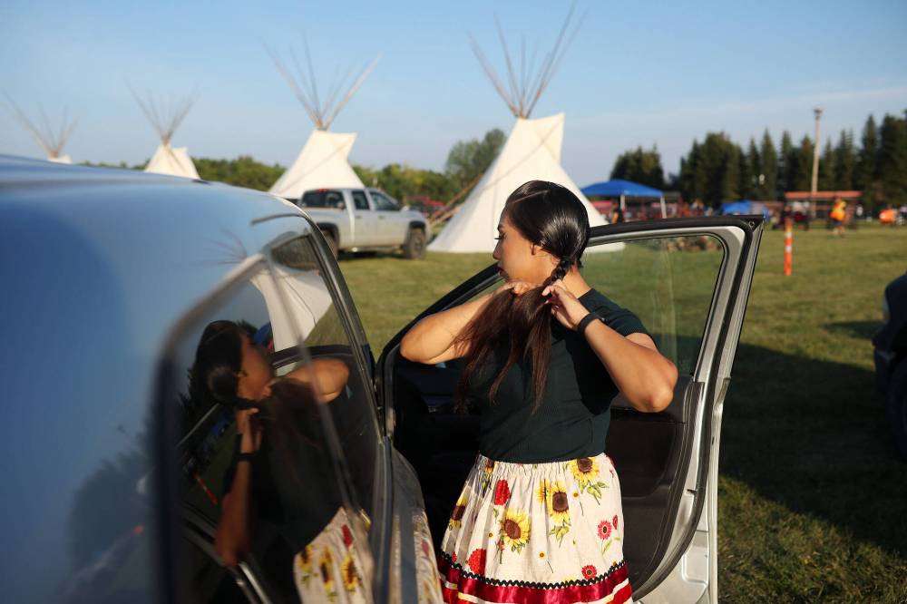 Selena Hanska of Birdtail First Nation does her hair while getting ready for the Sioux Valley Dakota Nation Pow Wow on Friday evening. (Tim Smith/The Brandon Sun)