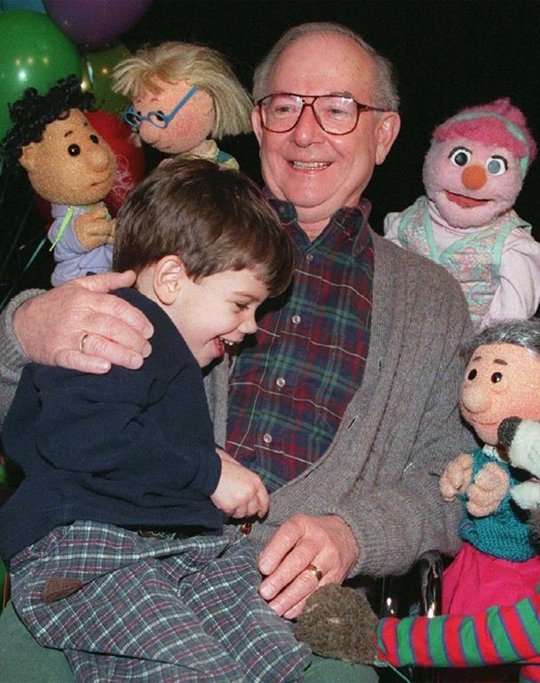 Ernie Coombs, 67, celebrates with a young fan after the taping of the final Mr. Dressup show in Toronto, Wednesday, Feb. 14, 1996. THECANADIAN PRESS/Frank Gunn