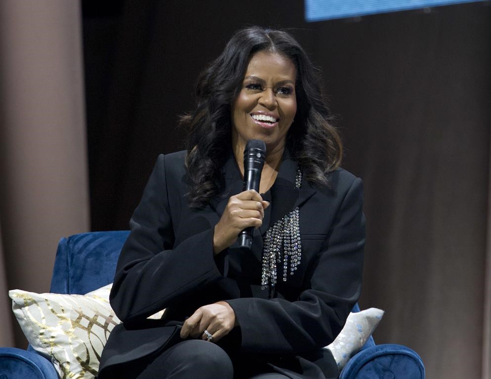 FILE - Former first lady Michelle Obama speaks to the crowd as she presents her anticipated memoir