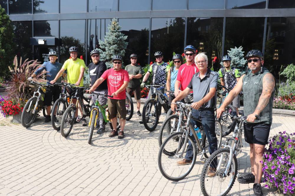 A group of local cycling enthusiasts and city council candidates pose for a photo Sunday afternoon outside city hall before departing on a tour of Brandon's various multi-use recreational paths. (Kyle Darbyson/The Brandon Sun)