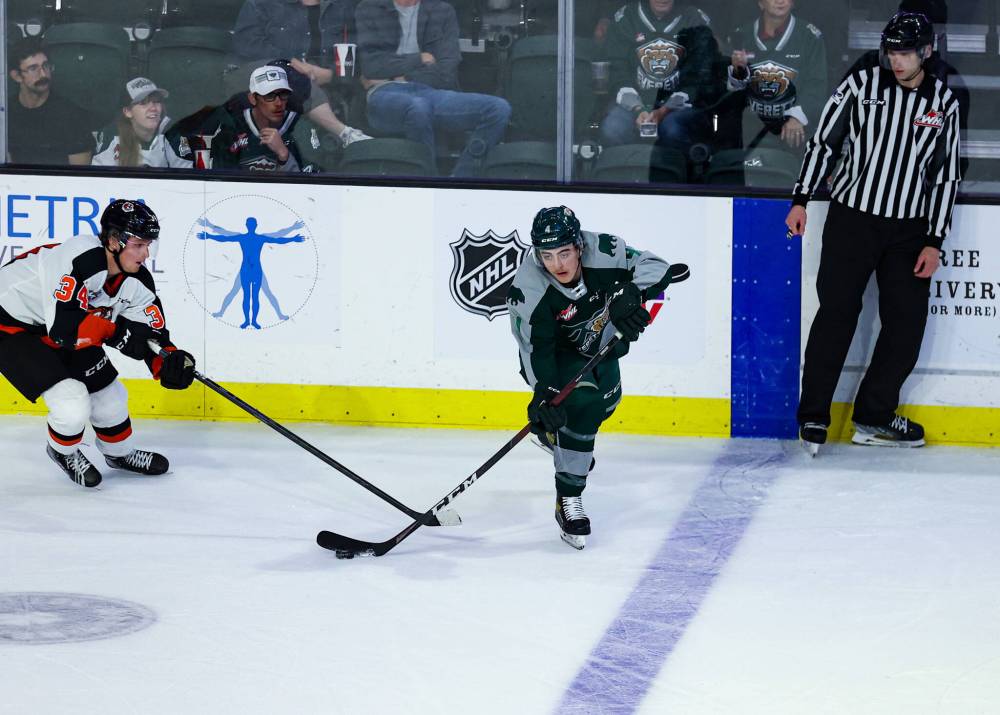 Dexter Whittle, shown making a pass against Medicine Hat Tigers forward Andrew Basha (34) earlier this season, said he and his Everett Silvertips are pushing to stay with Seattle and Portland at the top of the U.S. Division. (Kristin Ostrowski/Everett Silvertips)