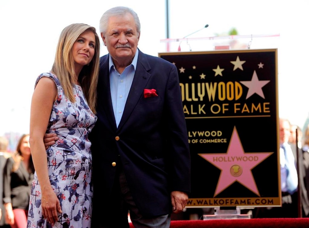 FILE - Actress Jennifer Aniston, left, poses with her father, actor John Aniston, after she received a star on the Hollywood Walk of Fame in Los Angeles on Feb. 23, 2012. John Aniston, the Emmy-winning star of the daytime soap opera “Days of Our Lives” and father of Jennifer Aniston, has died at age 89. The actor’s daughter posted a tribute to him Monday morning on Instagram, announcing that he had died Friday, Nov. 11. (AP Photo/Chris Pizzello, File)