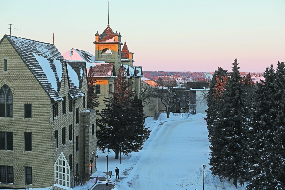 A pedestrian walks across the Brandon University campus on a cold winter afternoon. (File)