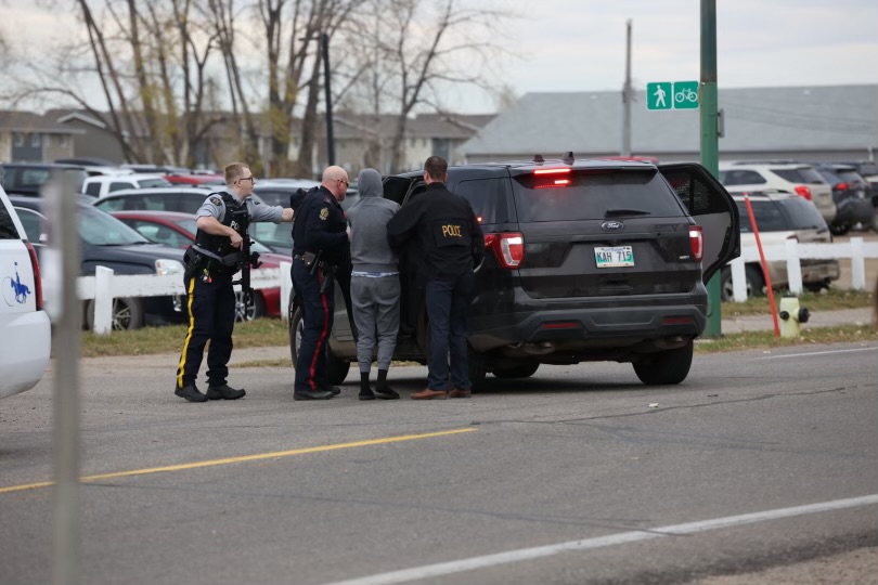 Brandon police take a person into custody outside Crocus Plains Regional Secondary School Tuesday morning. It's unclear if any charges have been laid in the Tuesday incident. (Tim Smith/The Brandon Sun)