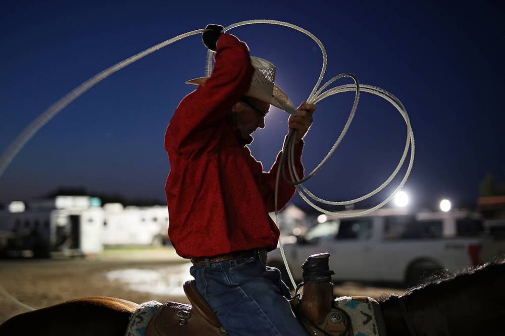 Riley Wilson of Cardston, Alta., warms up for the team roping event before competing at the Virden Indoor Rodeo in August.