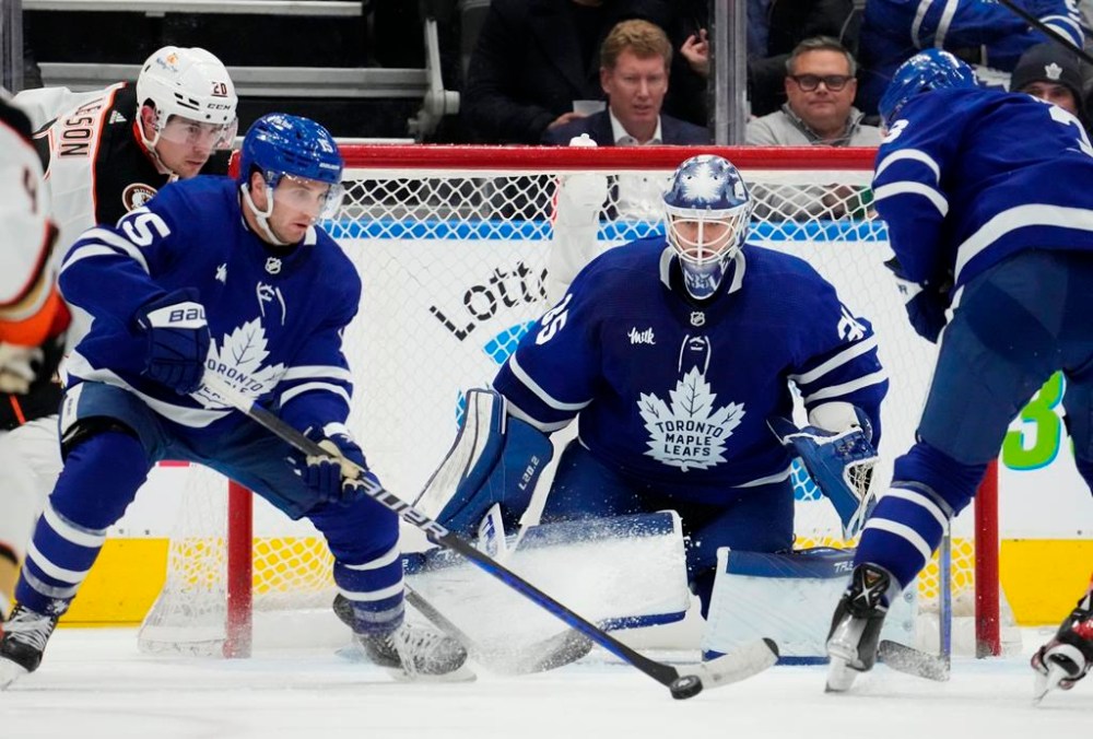 Toronto Maple Leafs' Alexander Kerfoot (15) plays the puck as Anaheim Ducks' Brett Leason (20) and Maple Leafs goaltender Ilya Samsonov (35) look on during second period NHL hockey action in Toronto on Tuesday, December 13, 2022. THE CANADIAN PRESS/Frank Gunn