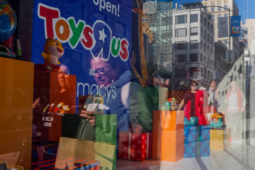 Shoppers pass the Toys R Us display outside Macy’s Union Square as they walk to catch Black Friday deals in San Francisco on Nov. 25. Louise McEwan says teaching children to practise gratitude around the holidays could reduce consumerism’s negative effects. (San Francisco Chronicle)