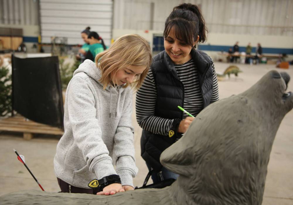 Kaydence and mom Carol Boyechko retrieve arrows from the 3D wolf target during the Manitoba 3D Archery Challenge at the Keystone Centre on Sunday. (Michele McDougall/The Brandon Sun)