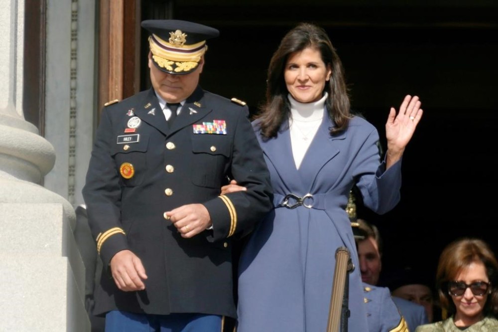 Former South Carolina Gov. Nikki Haley, right, waves as she and her husband, Michael Haley, left, are introduced at the second inaugural of Gov. Henry McMaster on Wednesday, Jan. 11, 2023, in Columbia, S.C. (AP Photo/Meg Kinnard)