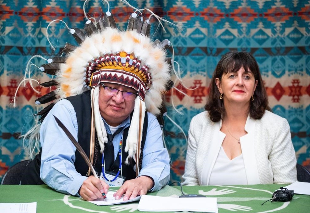 Chief Desmond Bull and assistant deputy minister for Indigenous Services Canada, Catherine Lapp, sign a bilateral agreement between Louis Bull Tribe and the Government of Canada to support Bill C-92, in Maskwacis, south of Edmonton on Wednesday Feb. 1, 2023. The historic agreement enables the First Nation to administer jurisdiction over its own child and family services. THE CANADIAN PRESS/Jason Franson