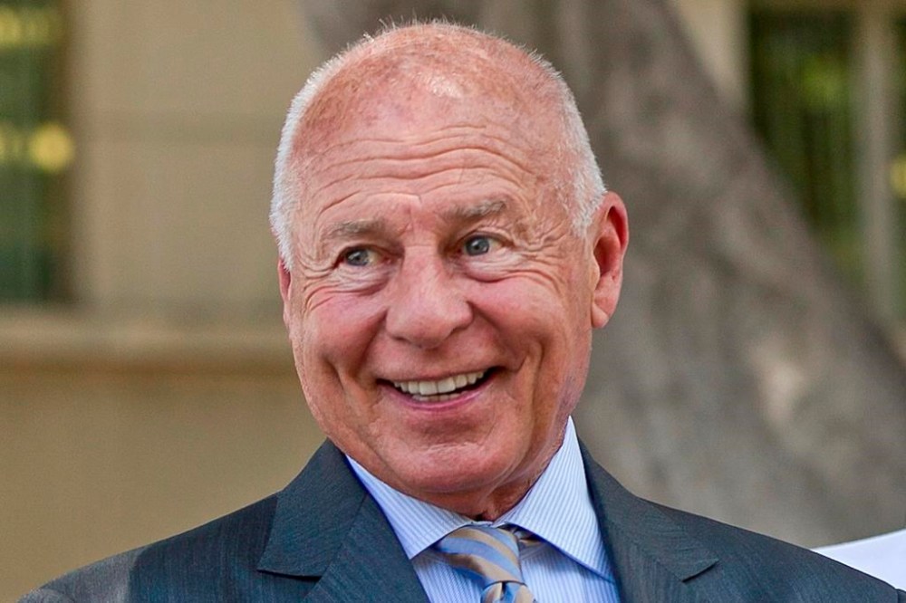 FILE - Attorney Tom Girardi smiles outside the Los Angeles courthouse on Wednesday, July 9, 2014. Disbarred and disgraced Los Angeles celebrity lawyer Tom Girardi has been indicted in Chicago on charges of stealing $3 million from clients who lost family members in the 2018 Lion Air crash. (AP Photo/Damian Dovarganes, File)