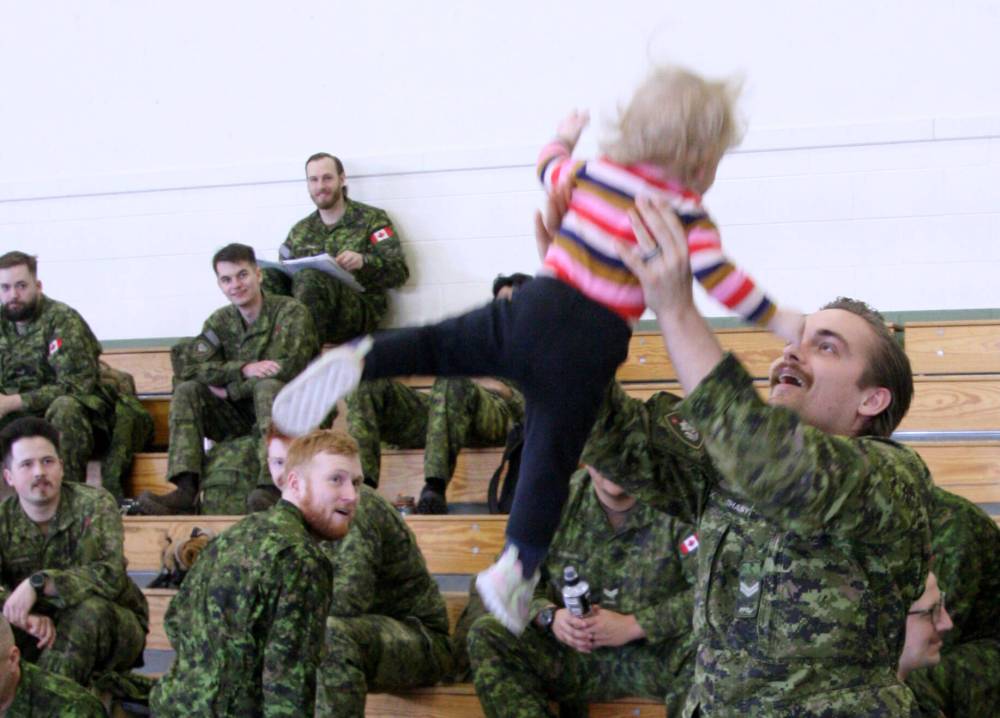 Corp. Tibor Tihanyi tosses and catches his 15-month-old daughter Arbela as they play at Kapyong Barracks at Canadian Forces Base Shilo. Tihanyi said goodbye to his family on Monday as he's part of a group of 100 Shilo soldiers who will serve a six-month rotation in the U.K. as part of Operation Unifier, an ongoing effort to train Ukrainians in the defence of their country. (The Brandon Sun)