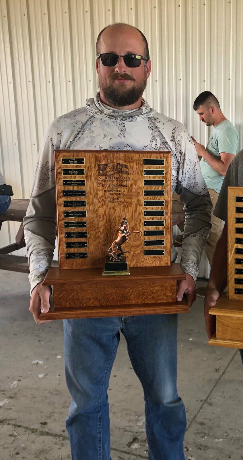 Scott Kyle is shown with his award for winning his category at the F-Class title at the North Dakota Long Range State Championship. He and his team will travel to South Africa to compete in the world championships in March.