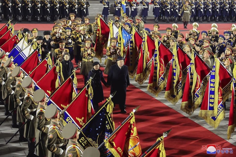 In this photo provided by the North Korean government, North Korean leader Kim Jong Un, center right, reviews an honor guard with his daughter, center left, and his wife Ri Sol Ju during a military parade to mark the 75th founding anniversary of the Korean People’s Army on Kim Il Sung Square in Pyongyang, North Korea Wednesday, Feb. 8, 2023. Independent journalists were not given access to cover the event depicted in this image distributed by the North Korean government. The content of this image is as provided and cannot be independently verified. Korean language watermark on image as provided by source reads: