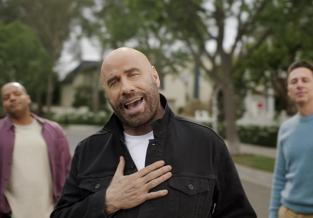 This photo provided by T-Mobile shows Zach Braff and Donald Faison, Zach Braff and John Travolta in scene from T-Mobile 2023 Super Bowl NFL football spot. Big name advertisers are paying as much as $7 million for a 30-second spot during the Super Bowl on Sunday, Feb. 12, 2023. (T-Mobile via AP)
