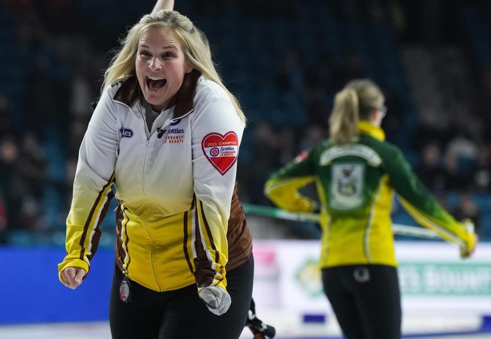 Manitoba skip Jennifer Jones celebrates after defeating Northern Ontario skip Krista McCarville, back right, in a playoff match to reach the final at the Scotties Tournament of Hearts, in Kamloops, B.C., on Saturday, February 25, 2023. THE CANADIAN PRESS/Darryl Dyck