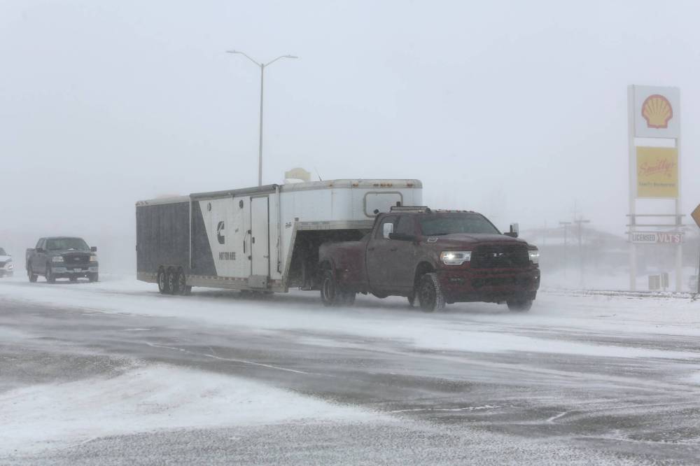 Motorists travel west on the Trans-Canada Highway through Brandon on Saturday afternoon as a major blizzard engulfs the Westman region. (Kyle Darbyson/The Brandon Sun)