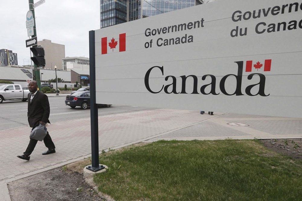 Razak Iyal, one of two asylum seekers who walked across the Canada/US border in December and lost his fingers because of severe frostbite, is photographed as he enters his refugee hearing in Winnipeg, Tuesday, June 13, 2017. THE CANADIAN PRESS/John Woods