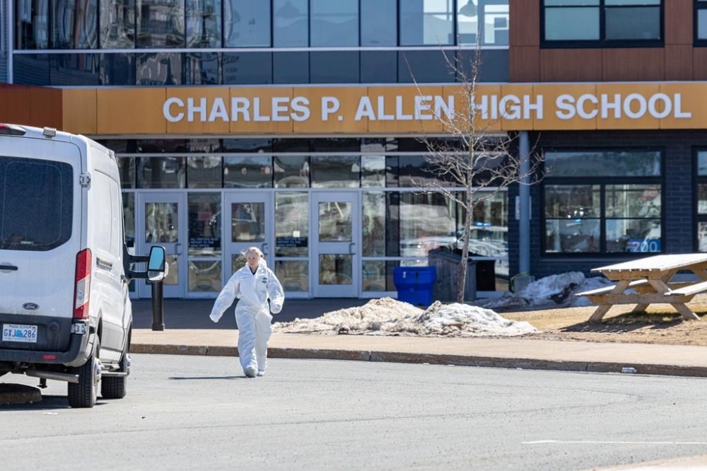 Forensics on the scene at Charles P. Allen High School in Halifax, Monday, March 20, 2023. The Halifax school where two staff were stabbed on Monday is reopening today with counselling being provided.THE CANADIAN PRESS/Riley Smith