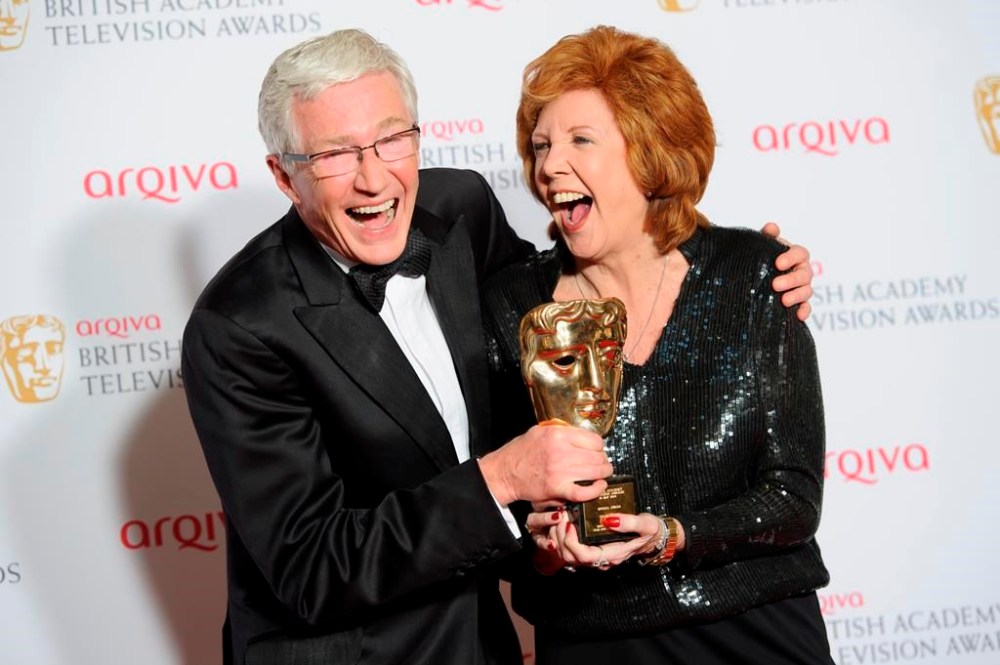 FILE - British presenters Paul O'Grady, left, and Cilla Black joke with her Special Award at the British Academy Television Awards at a central London venue, Sunday, May 18, 2014. Entertainer Paul O’Grady, who achieved fame as drag queen Lily Savage before becoming a much-loved comedian and host on British television, has died. He was 67. (Photo by Jonathan Short/Invision/AP, File)