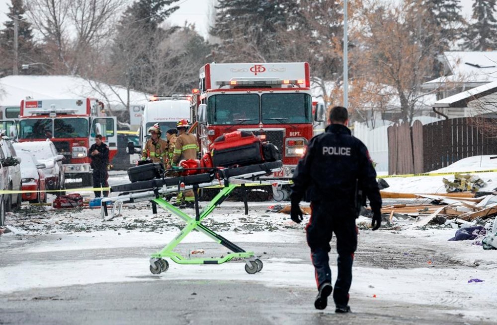 First responders attend the scene of a house explosion in Calgary, Alta., Monday, March 27, 2023. A member of the South Sudanese community says the 10 victims of Monday's home explosion were blown into the air before falling into the fiery basement below. THE CANADIAN PRESS/Jeff McIntosh