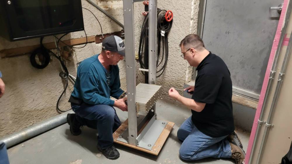 Brandon Amateur Radio Club members Darrell Bercier and Rob Boux help install a digital mobile radio repeater on top of Princess Towers this past November. (Submitted)