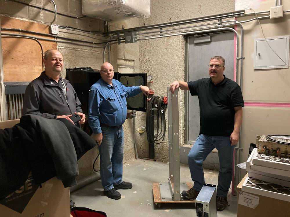 Brandon Amateur Radio Club members Auke De Jong, Calvin Winter and Rob Boux help install a digital mobile radio repeater on top of Princess Towers this past November. (Submitted)
