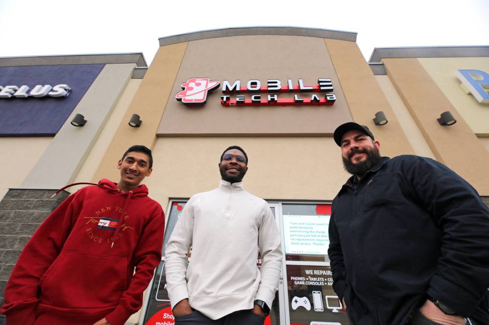 Mobile Tech Labs co-founders Kyle Jagassar (left) and Daniel Okagbare (centre) and operations manager Gilles Laurin stand in front of the company's new Brandon location at the Corral Centre. (Colin Slark/The Brandon Sun)