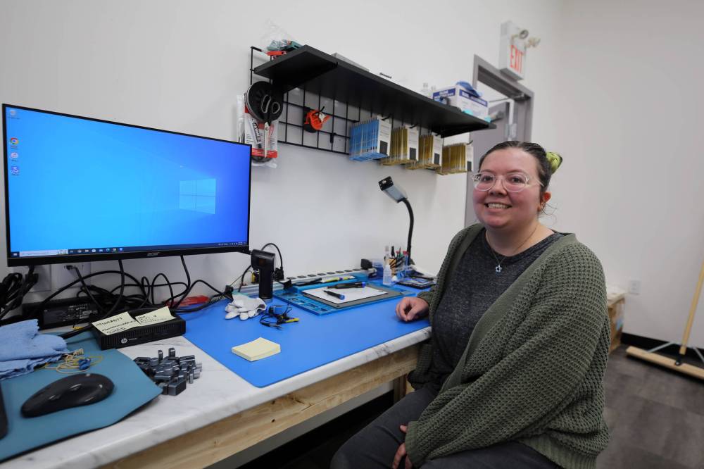 Mobile Tech Labs advanced electronics technician Kelly Paddock shows off her repair station at the company's recently opened Brandon location on Wednesday. (Colin Slark/The Brandon Sun)