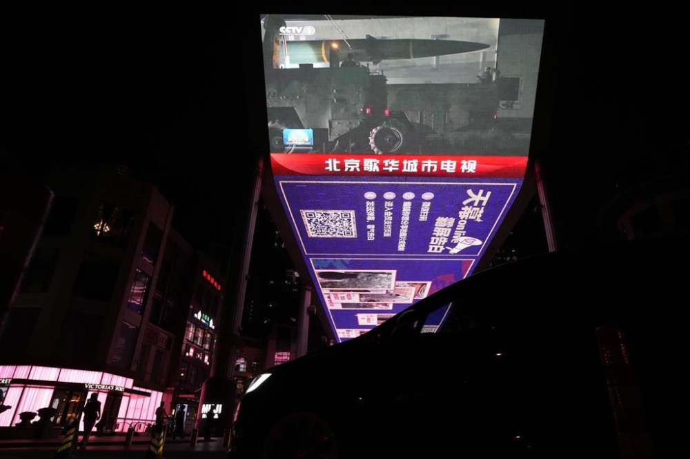 An outdoor screen shows the recently concluded Joint Sword exercise around Taiwan depicting a missile being prepared during the evening news broadcast in Beijing, Monday, April 10, 2023. China's military declared Monday it is