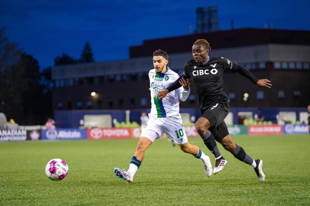 York United FC's Oussama Alou, left and Vancouver FC's Ibrahim Bakare battle for the ball during Canadian Championship soccer action in Toronto in this Wednesday, April 19, 2023 handout photo. THE CANADIAN PRESS/HO, CPL, CHANT *MANDATORY CREDIT*