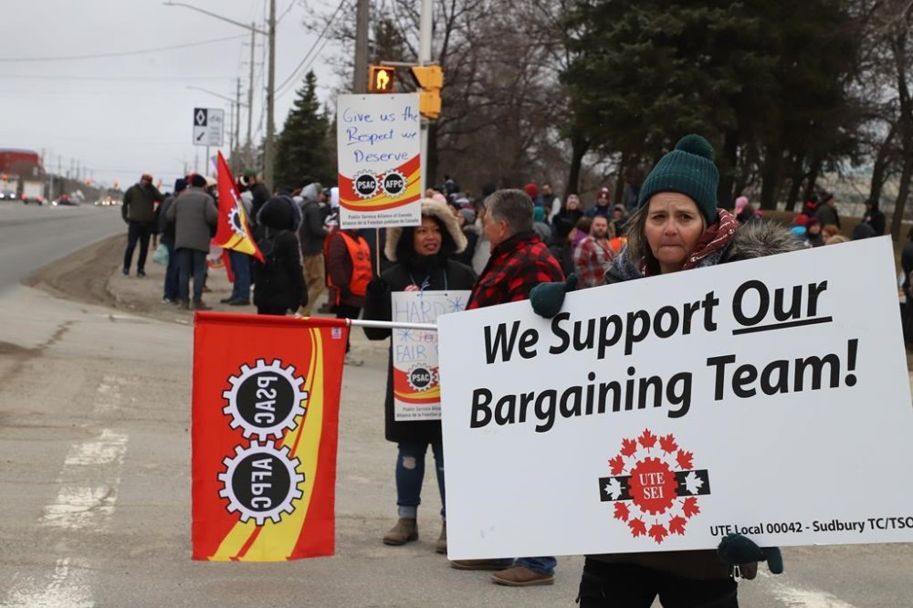 PSAC workers and supporters picket outside the Canada Revenue Agency office in Sudbury, Ont. on Wednesday, April 19, 2023. Canada's largest federal public-service union and the federal government remain at the bargaining table as workers strike and service disruptions begin to be felt across the country. THE CANADIAN PRESS/Gino Donato