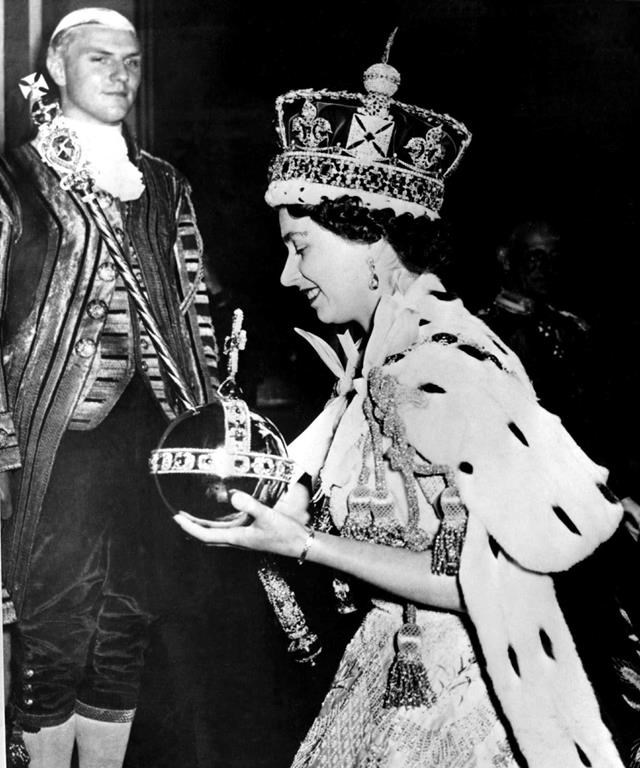 Queen Elizabeth II wears the bejeweled Imperial Crown and carries the orb and scepter as she leaves Westminster Abbey on June 2, 1953 at the end of the Coronation Ceremony. THE CANADIAN PRESS/AP