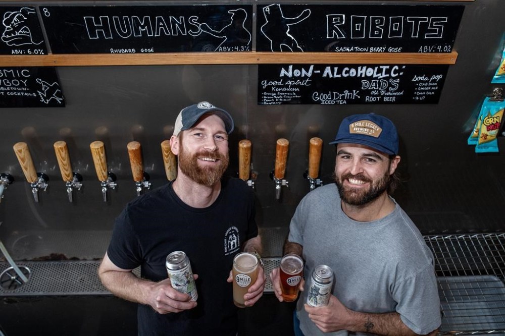 9 Mile Brewery co-Founder and head brewer Garrett Pederson, left, and assistant brewer Luke Clark stand for a photograph in the company’s tap room in Saskatoon on Wednesday, May 3, 2023. The Saskatoon brewery used ChatGPT to produce a beer recipe, then held a tasting challenge. THE CANADIAN PRESS/Liam Richards