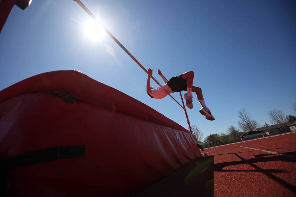 Charlie Gauthier, a Grade 8 student from École Harrison, leaps over the bar during high jump at the school's track and field day at the UCT Stadium on Friday. (Tim Smith/The Brandon Sun)