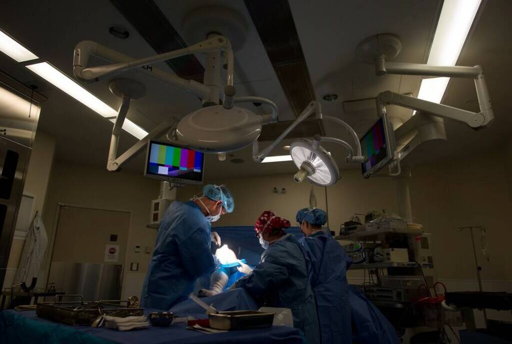 Surgeons are shown here at work at the Cambie Surgery Centre in Vancouver. The centre is one of two facilities (the other is in Toronto) accepting Manitoba patients for foot, ankle or shoulder surgeries. The province offered these options quietly, and Opposition Leader Wab Kinew suggests it's because Cambie's CEO is an advocate for private medical care.