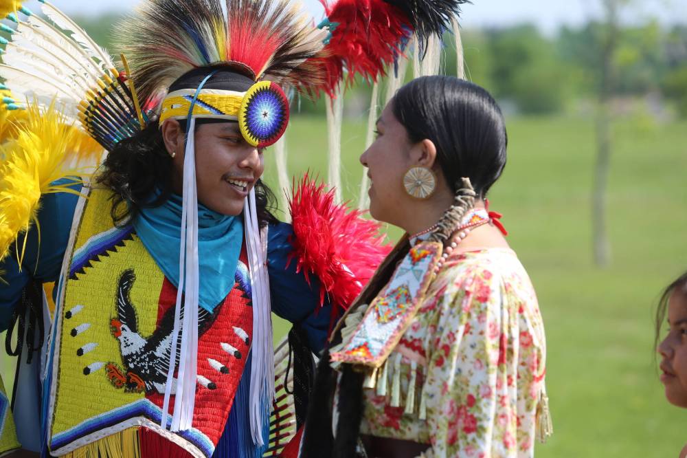 Jason and Jolene Taylor prepare for the Grand Entry during Wednesday's Our Journey, Indigenous Student Graduation Celebration at the Riverbank Discovery Centre.